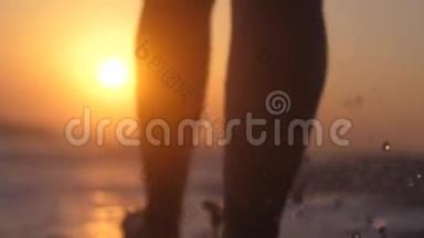快乐的年轻女子在令人惊叹的金色夕阳下，光着脚在大海上奔跑和跳跃，慢动作。 1920x1080